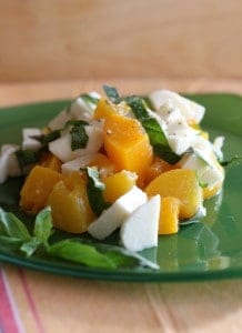 peach and mozzarella cheese salad on green plate