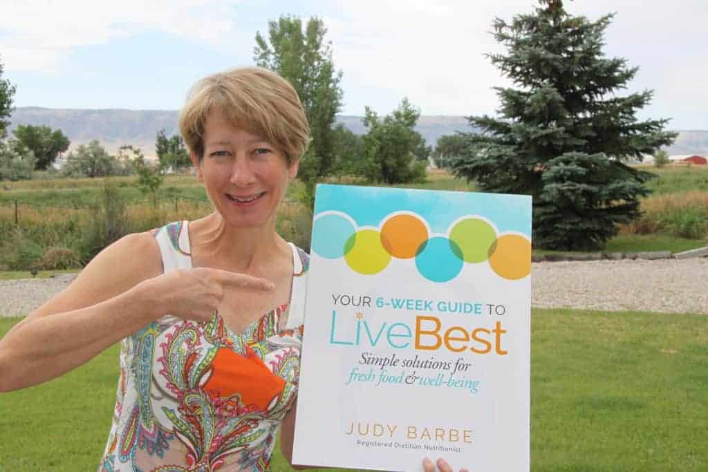 Photo of author with book cover