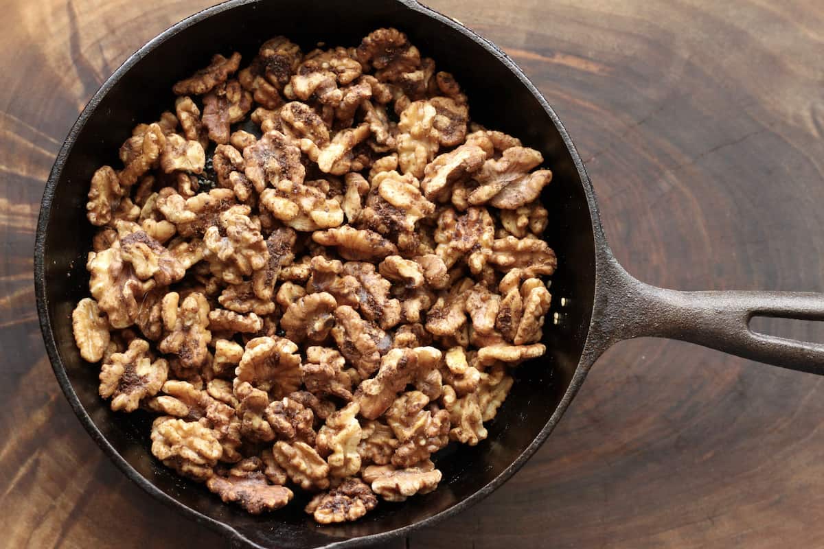 chai walnuts in a cast iron skillet