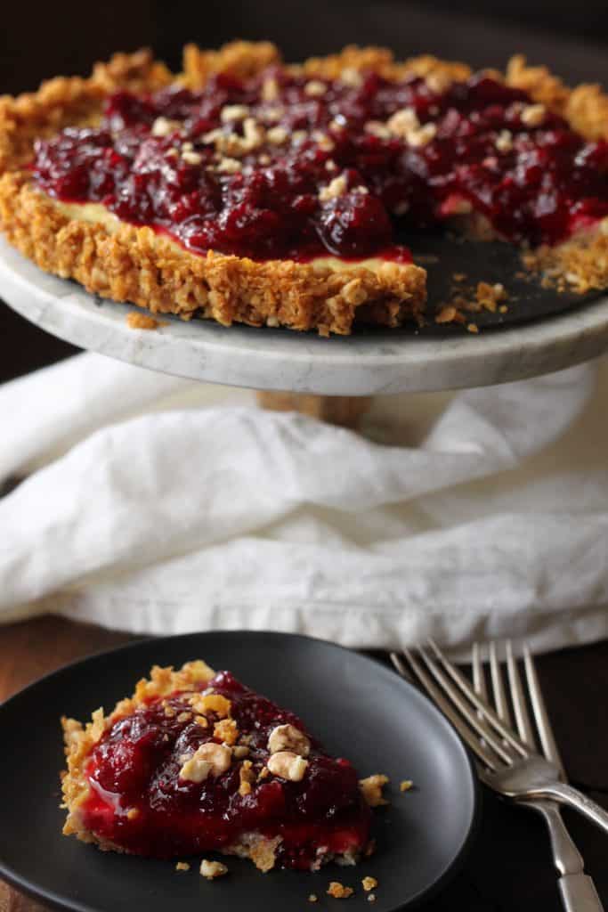 Cranberry Orange Yogurt Tart with a slice cut from the tart in front