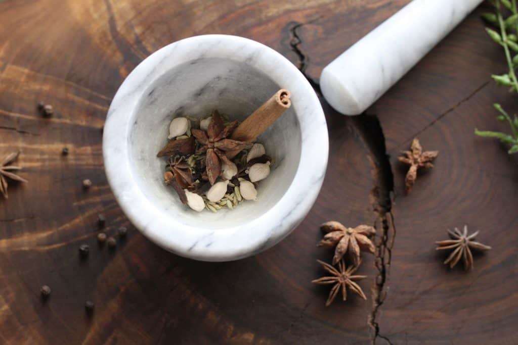 small mortar and pestle with whole spices