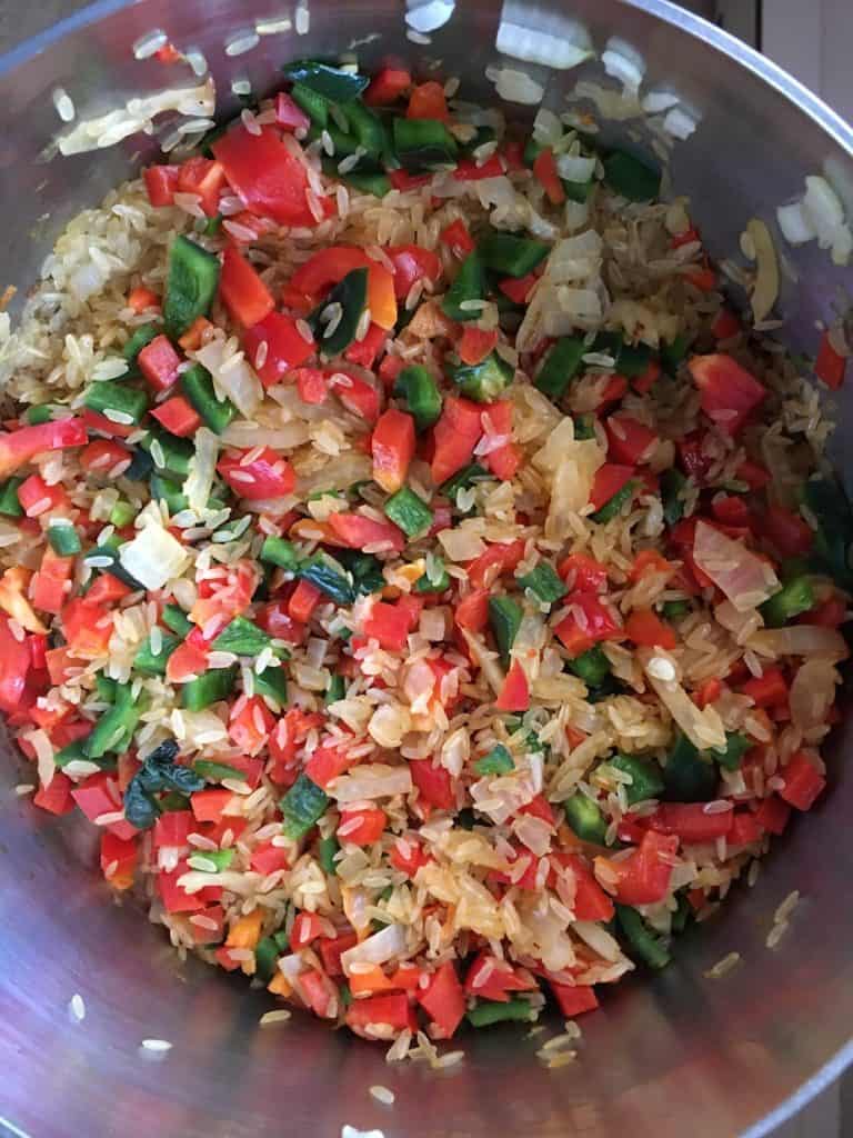 Rice, peppers and onions in a pan 