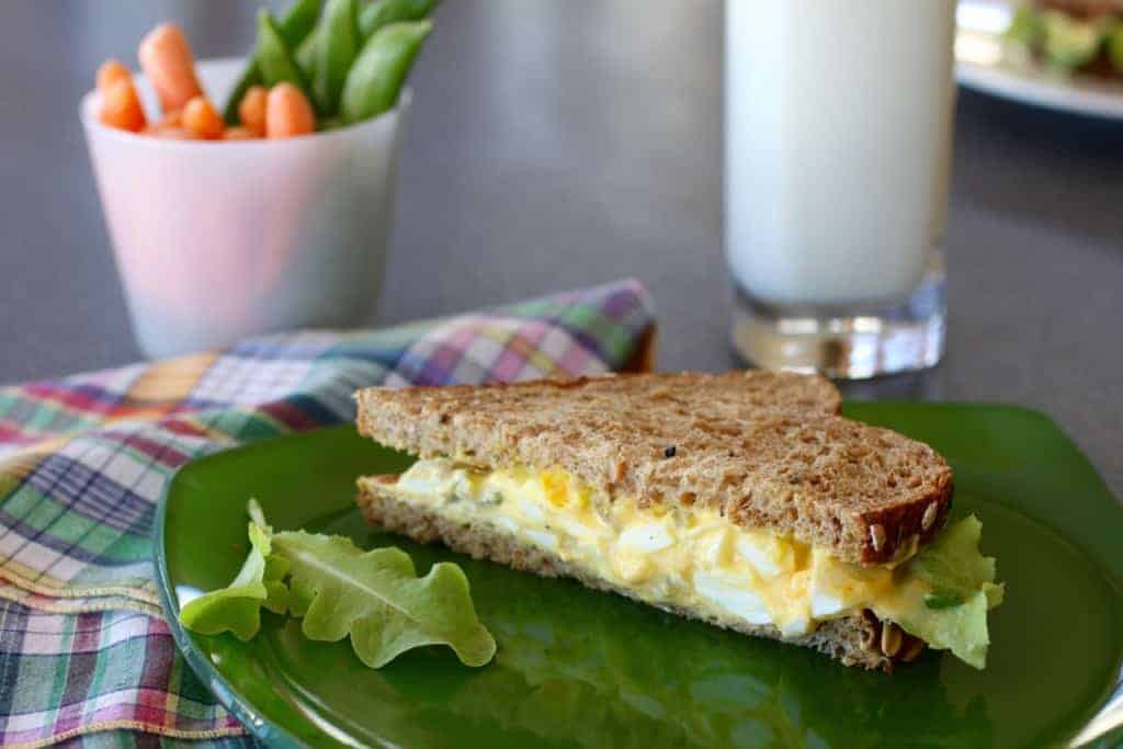 Curry Egg Salad sandwich with milk and carrots
