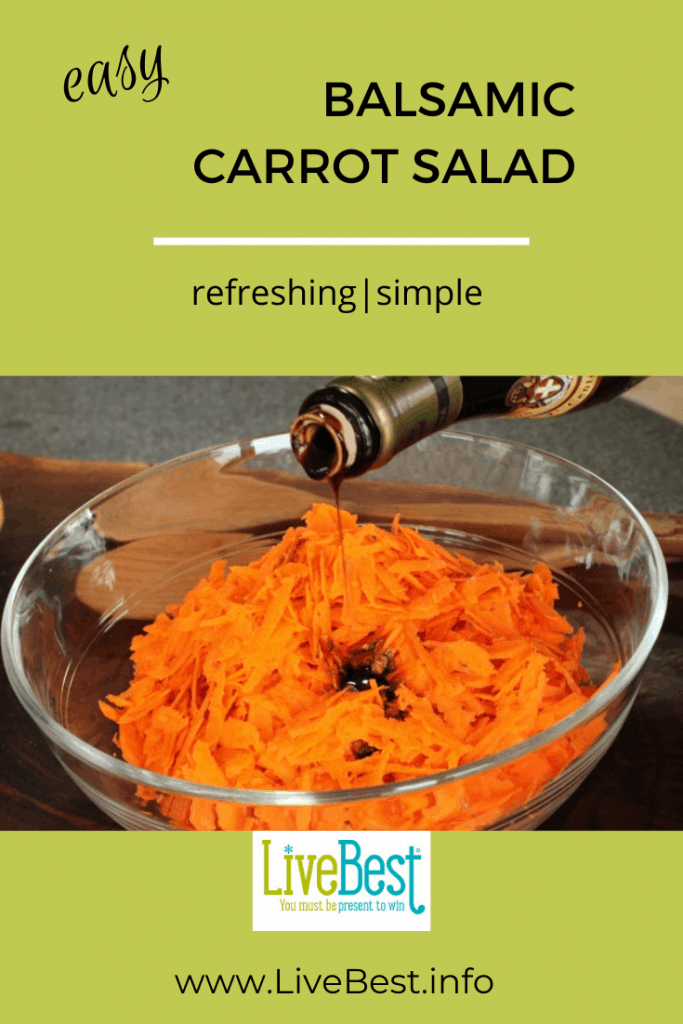 shredded carrots in a bow with balsamic vinegar drizzled over