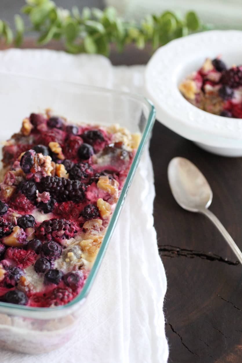 Pan of Berry Cardamom Baked Oats with a small serving bowl