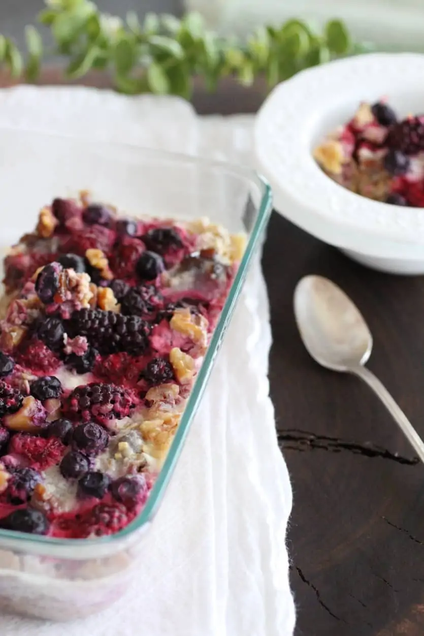 Pan of Berry Cardamom Baked Oats with a small serving bowl