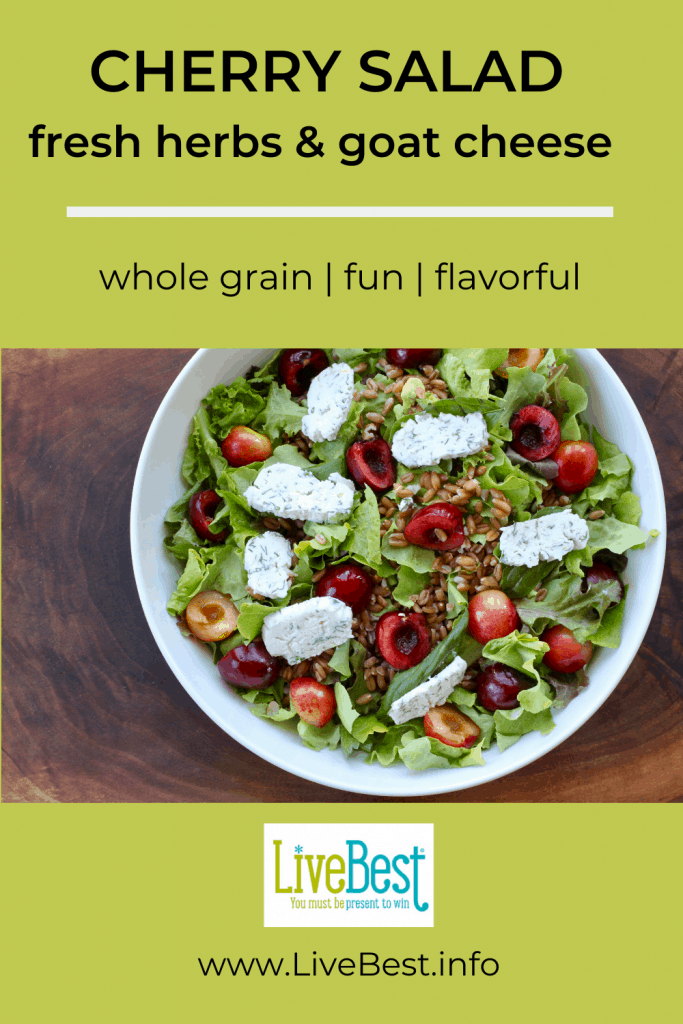 bowl of whole-grains and fresh cherry salad  with fresh herbs and goat cheese discs.