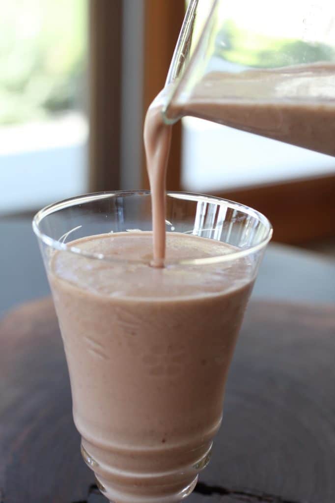 pouring Cherry Amaranth Almond Smoothie in a glass