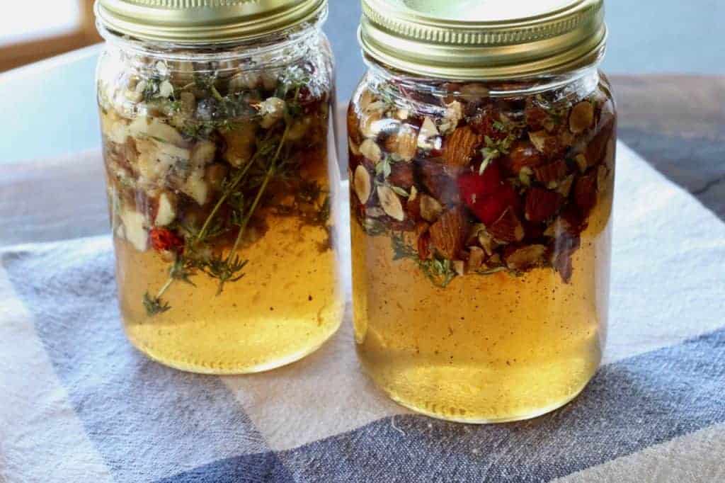 2 jars of honey infused with nuts and thyme