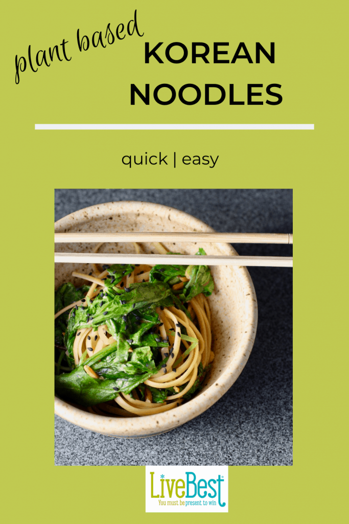 bowl of noodles and spinach with chopsticks