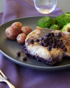 Baked Blueberry Pork Chops on plate with potatoes and broccoli