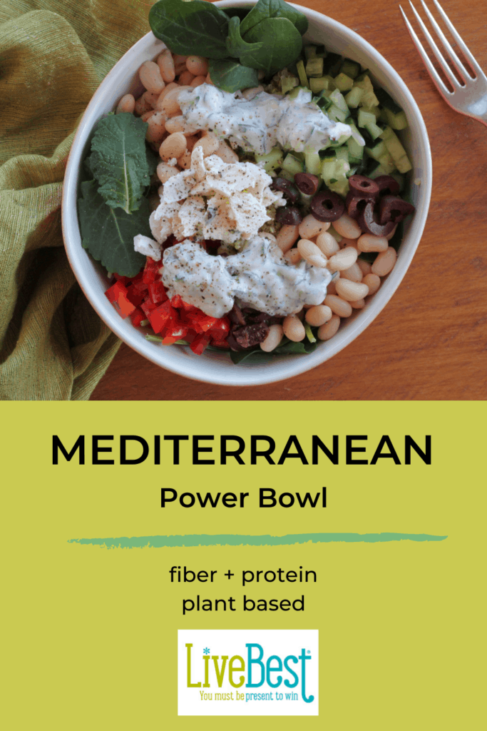 Mediterranean Quinoa Power Bowl with beans arugula, cucumber, red pepper, olives and yogurt sauce