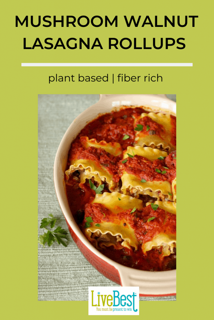 casserole dish with 5 mushroom walnut lasagna rollups in tomato sauce