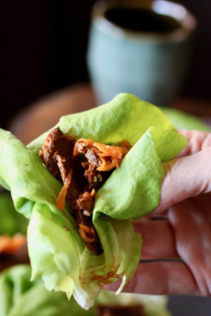 hand holding a Korean Beef lettuce wrap