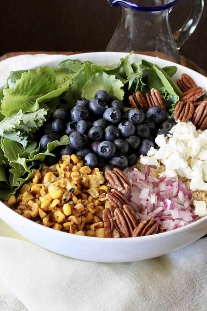 Blueberry, corn, quinoa, pecans, feta in a bowl