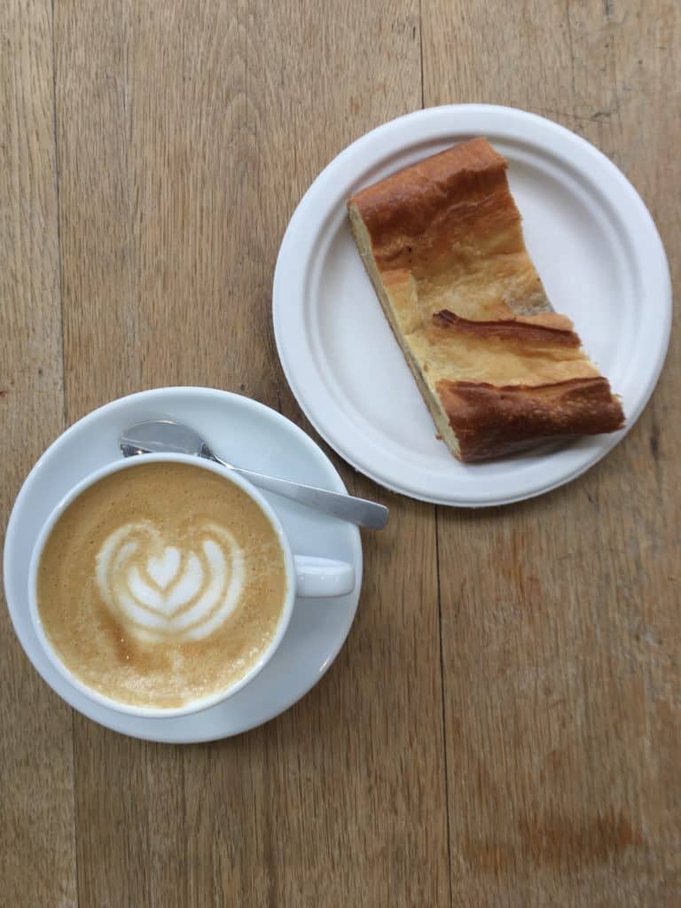 pastry and latte in table