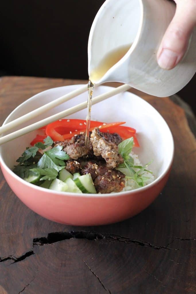 Beef sushi bowl with dressing poured on