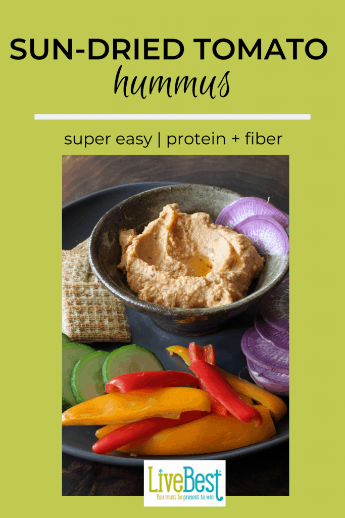 bowl of sun-dried tomato hummus with fresh vegetables