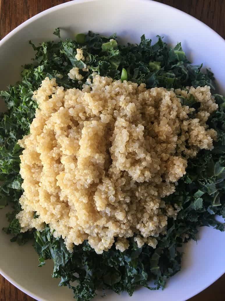 bowl of fresh chopped kale with quinoa on top