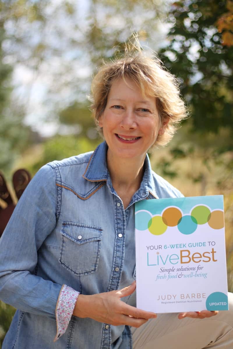 Judy holding book Your 6-week guide to LiveBest