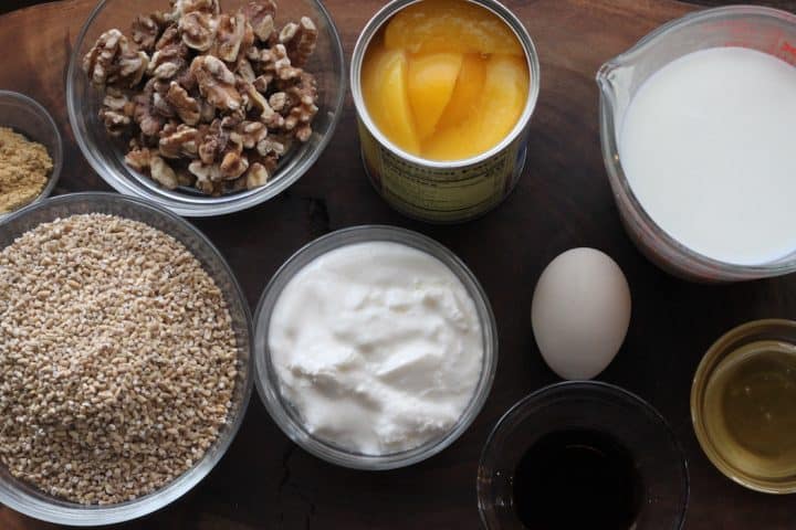 ingredients for baked oatmeal peaches, walnuts, egg, honey, ginger, yogurt, egg, and steel-cut oats