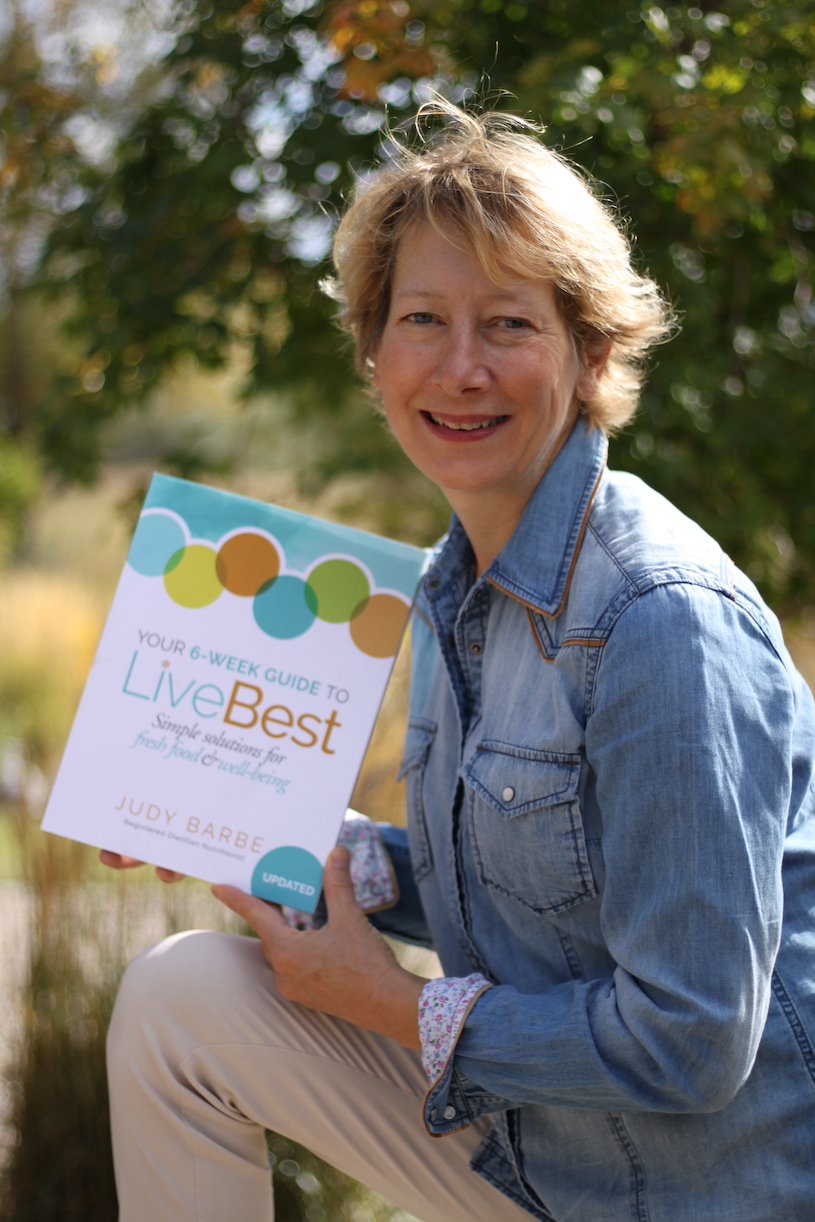 author Judy Barbe holding her book